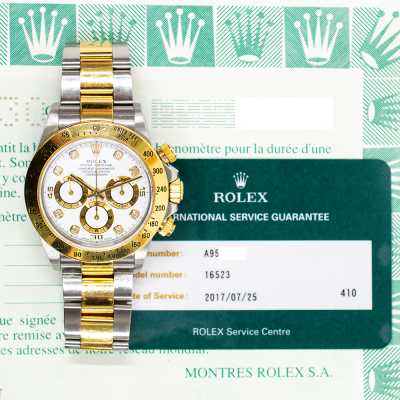 Rolex 16523G Daytona 40mm Rolesor racing chronograph featuring white diamond dial pre-owned luxury vintage